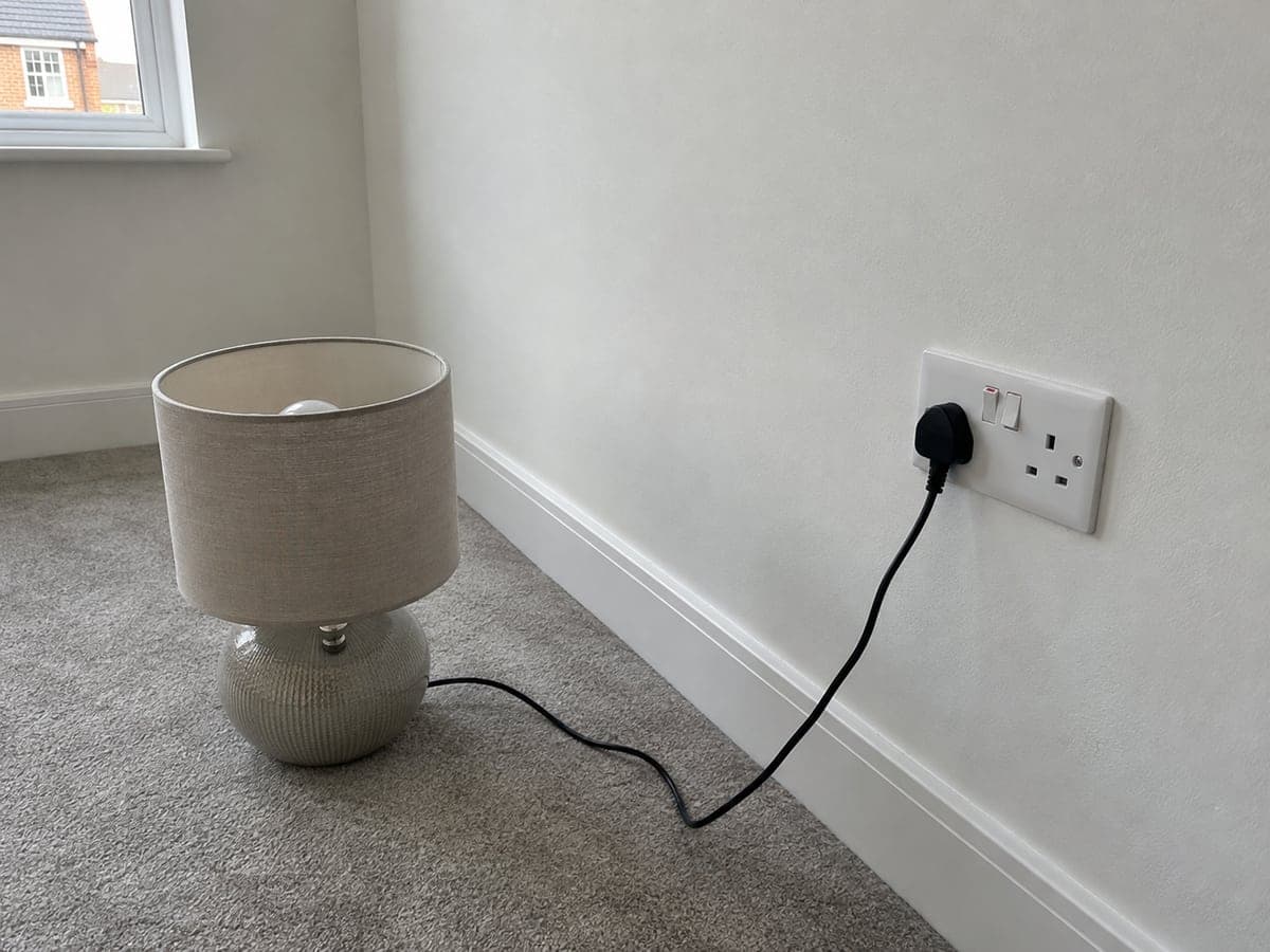 A lamp that worked at a nearby outlet did not illuminate from either receptacle of the double outlet low on the wall beside the window, with the outlet switches on.